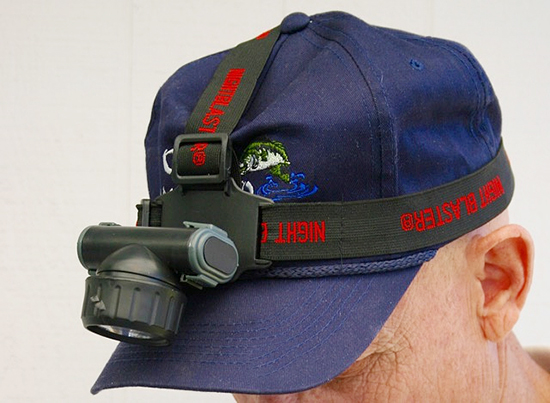 A light that straps to your head or attaches to your cap is handy at night.