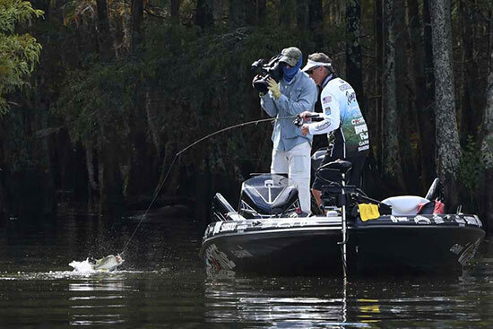 A cameraman captures the action on Championship Sunday, as I pull a fish from Lake Marion's shallow cypress trees.